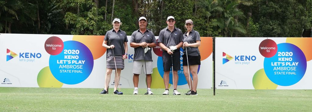 four happy golfers about to tee off